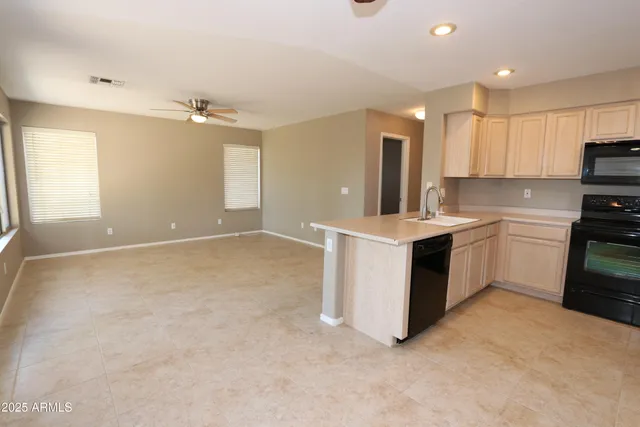 a kitchen with a stove sink and a refrigerator