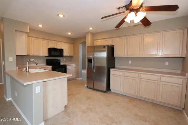 a kitchen with a sink a counter space cabinets and stainless steel appliances