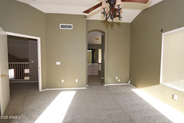 a view of a hallway with wooden floor and chandelier
