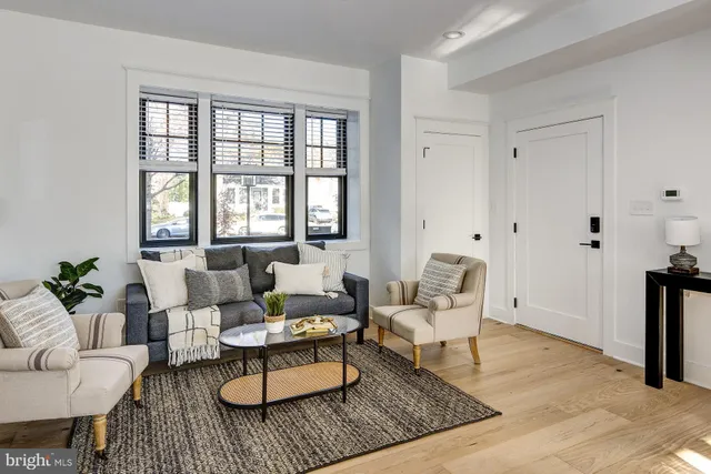 a kitchen with stainless steel appliances granite countertop a refrigerator a sink a stove a dining table and chairs