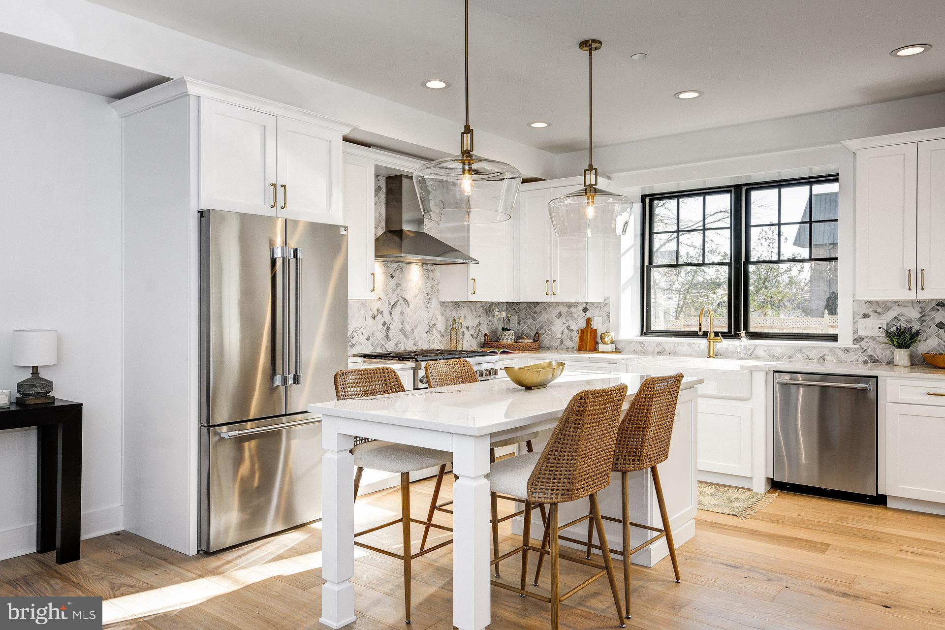 20 East Redman Avenue, Unit B Haddonfield, NJ 08033 - Photo 14 of 43 a kitchen with stainless steel appliances granite countertop a refrigerator a sink a stove a dining table and chairs