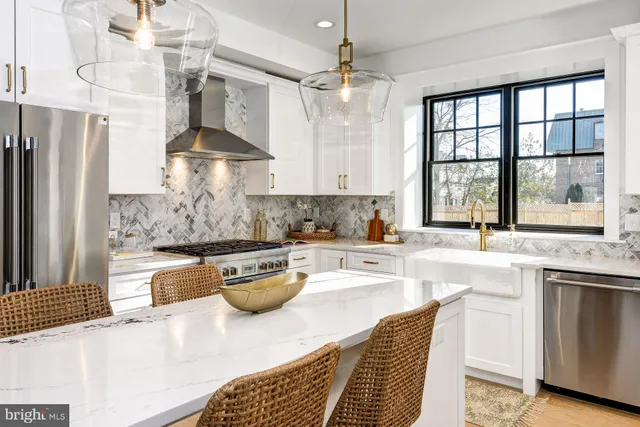 a kitchen with stainless steel appliances a sink stove and cabinets