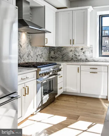a kitchen with a stove and a white cabinets