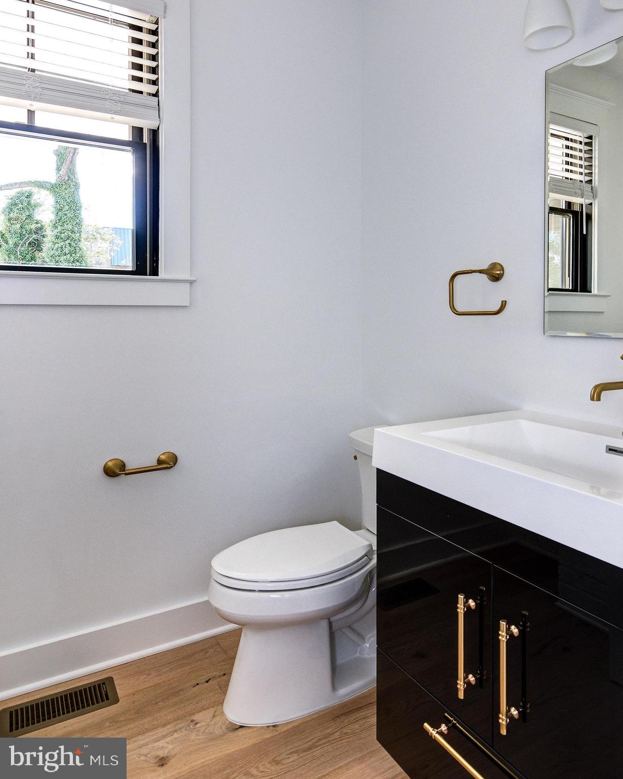 20 East Redman Avenue, Unit B Haddonfield, NJ 08033 - Photo 25 of 43 a bathroom with a toilet a sink and mirror