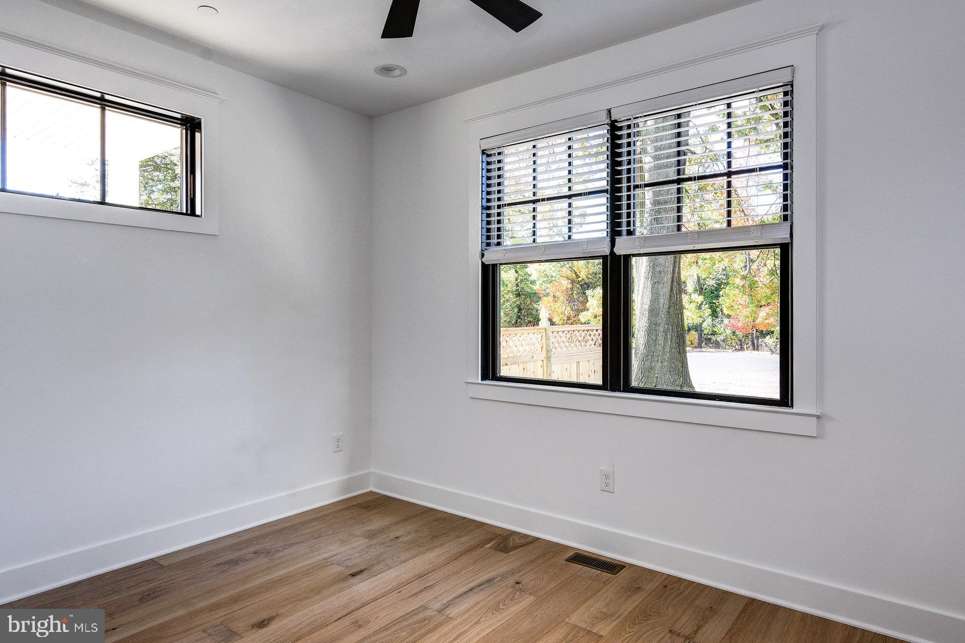 20 East Redman Avenue, Unit B Haddonfield, NJ 08033 - Photo 33 of 43 an empty room with wooden floor and windows