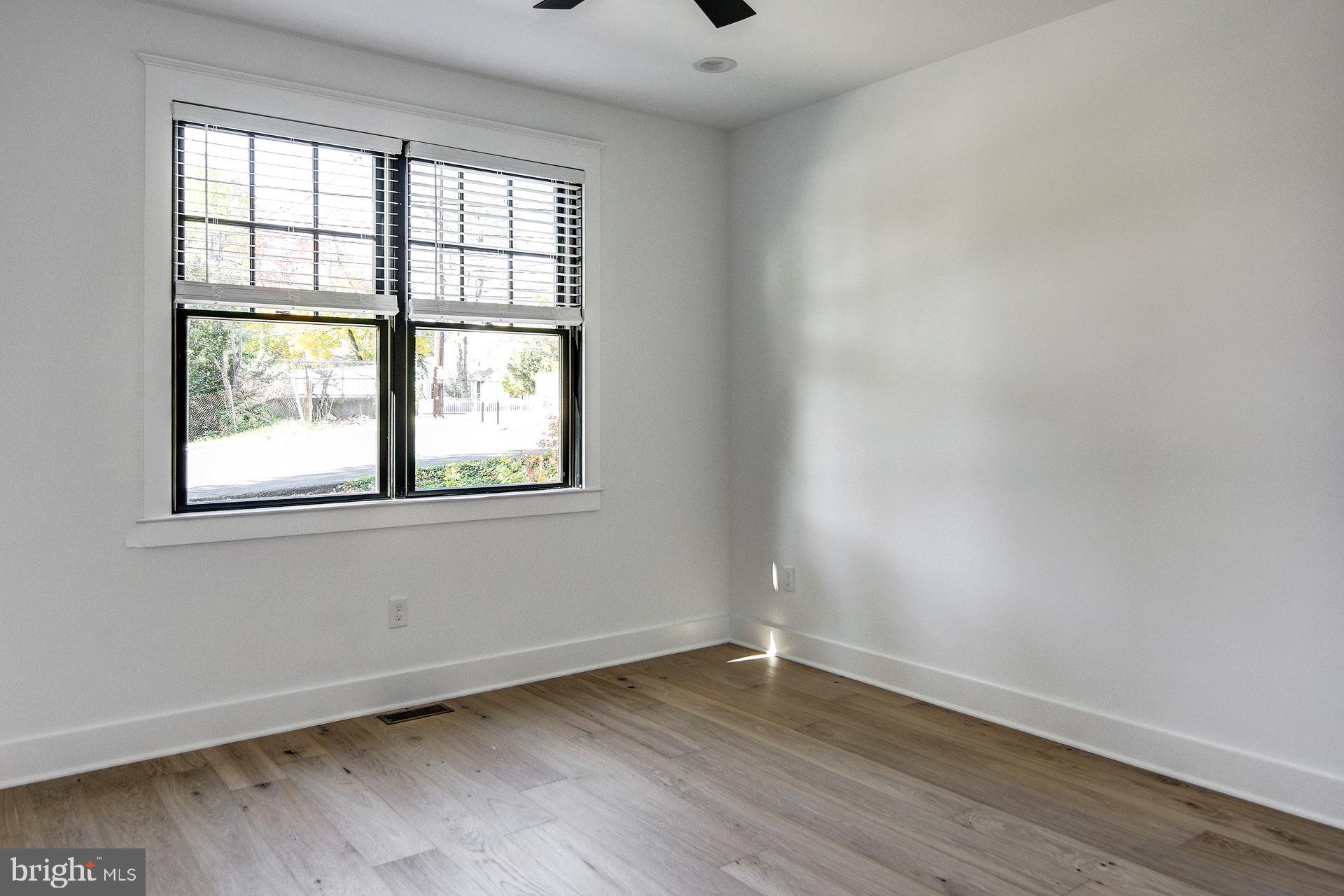 20 East Redman Avenue, Unit B Haddonfield, NJ 08033 - Photo 38 of 43 an empty room with wooden floor and windows