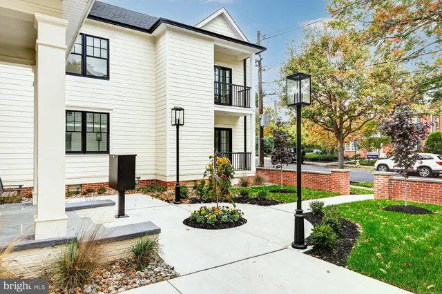 a front view of a house with a yard and fountain