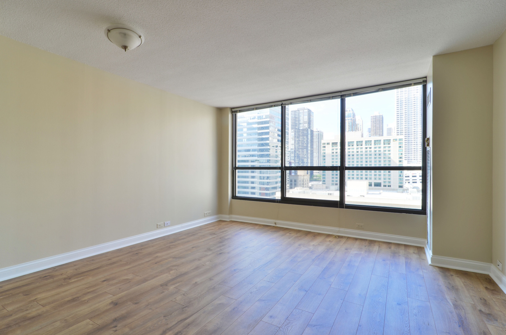 405 North Wabash Avenue, Unit 901 Chicago, IL 60611 - Photo 2 of 21 wooden floor in an empty room with a window