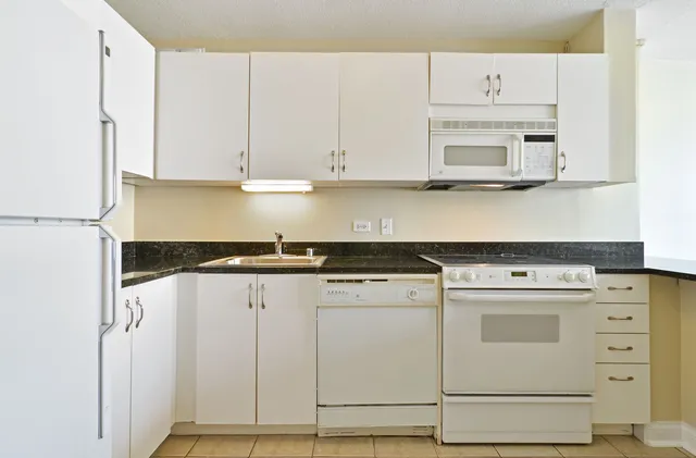 a kitchen with cabinets appliances and a sink