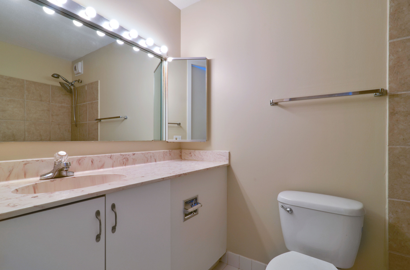 405 North Wabash Avenue, Unit 901 Chicago, IL 60611 - Photo 7 of 21 a bathroom with a sink a toilet a mirror and shower