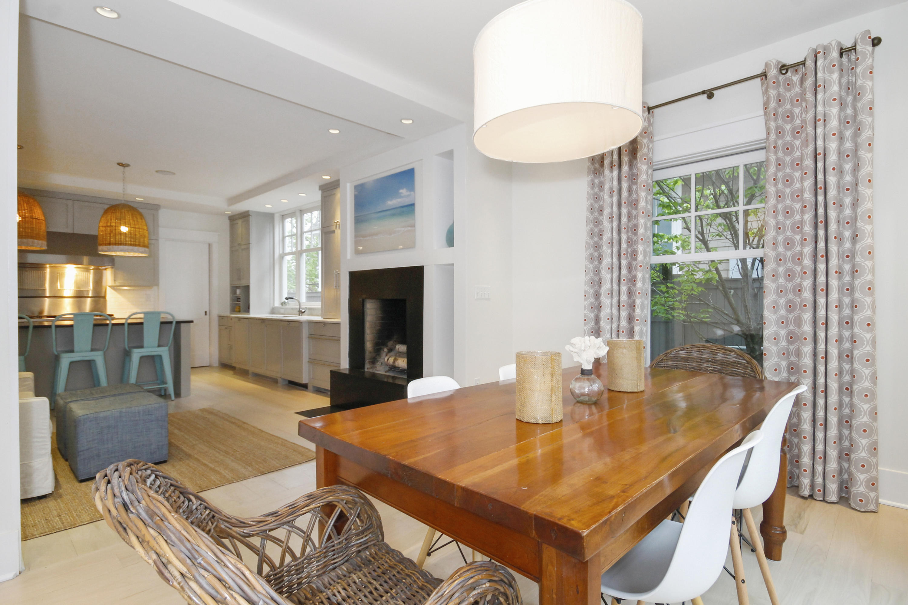 2 Rowayton Avenue Rowayton, CT 06853 - Photo 19 of 43 a living room with dining table and a fireplace