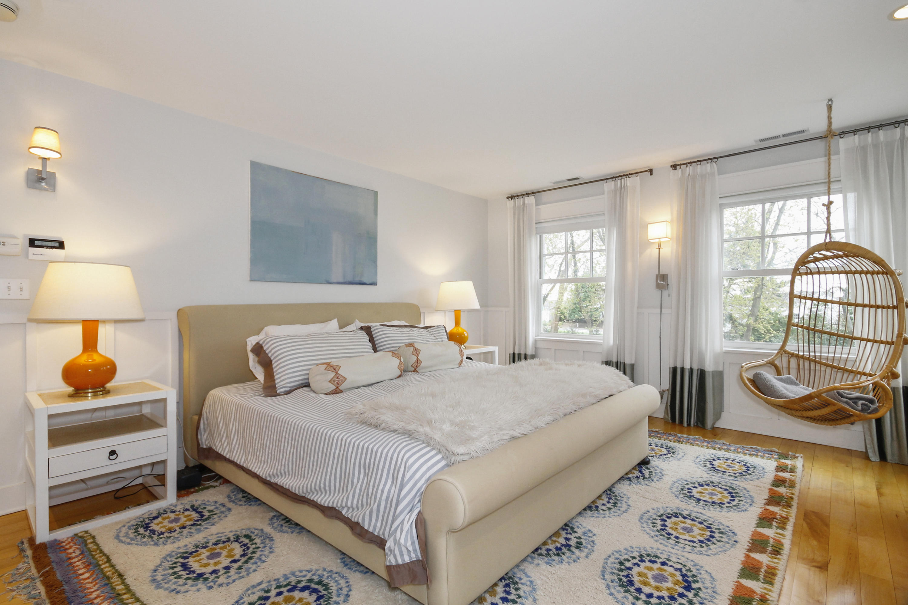 2 Rowayton Avenue Rowayton, CT 06853 - Photo 27 of 43 a bedroom with a bed a couch and dresser with wooden floor