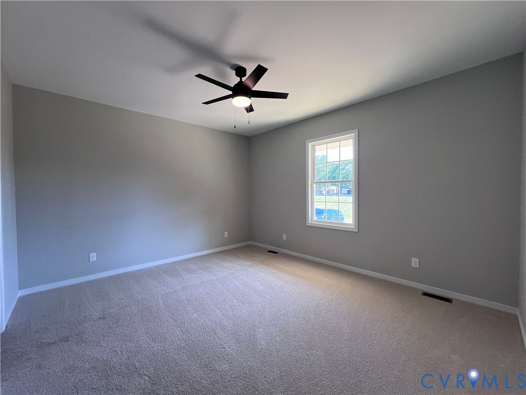 2905 Worsham Road Farmville, VA 23901 - Photo 11 of 23 Neutral tone wall paint with a window, ceiling fan