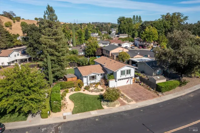 an aerial view of a house with a yard basket ball court and outdoor seating