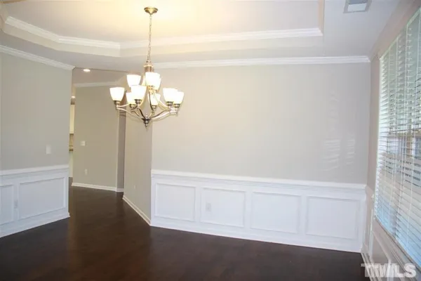 a view of a chandelier fan and wooden floor