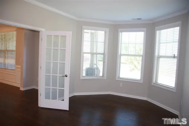 a view of a livingroom with wooden floor and a window