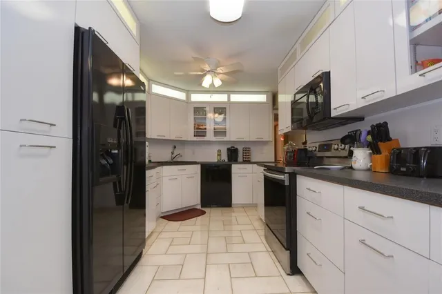 a kitchen with stainless steel appliances granite countertop a refrigerator and a stove