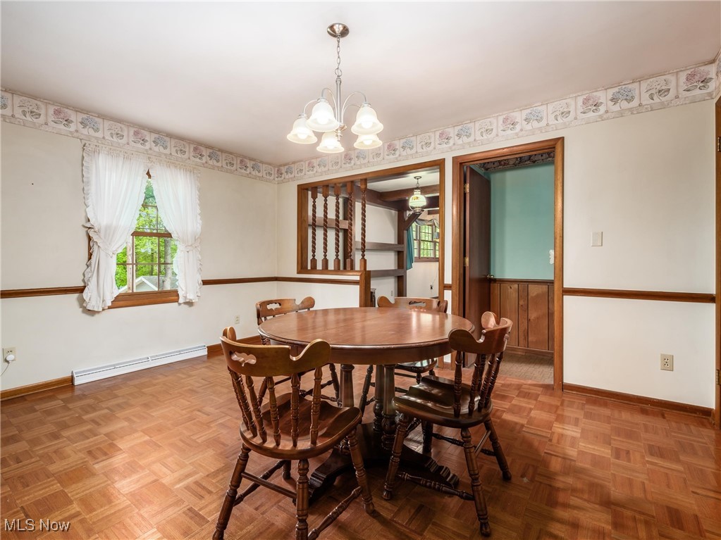975 Richey Road Zanesville, OH 43701 - Photo 4 of 27 Dining area with baseboard heating, baseboards, and a chandelier