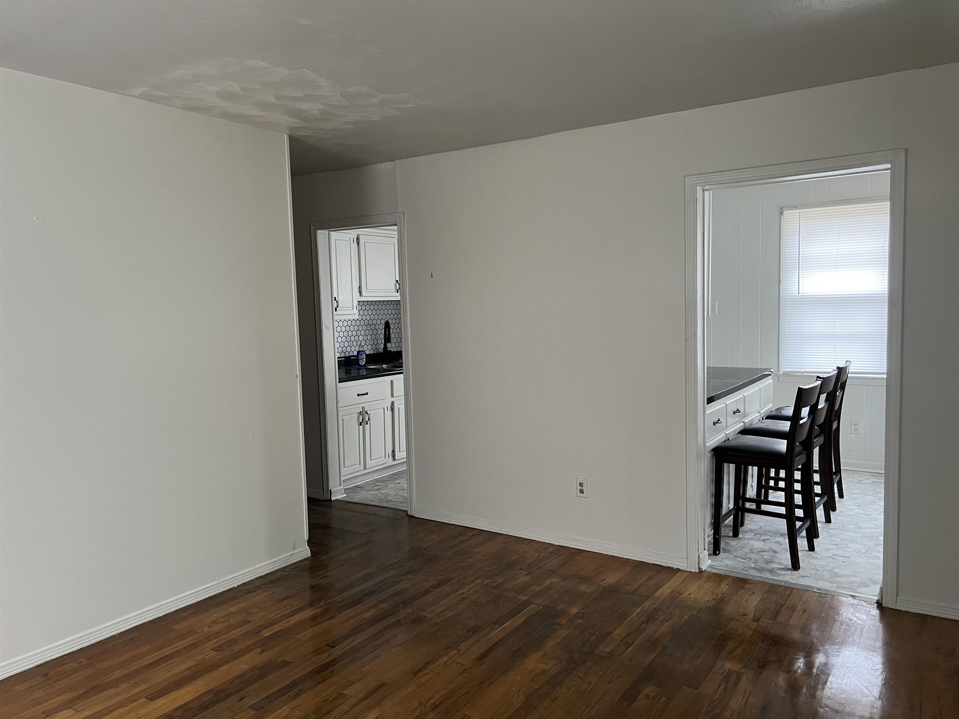 Unfurnished room featuring dark hardwood / wood-style flooring