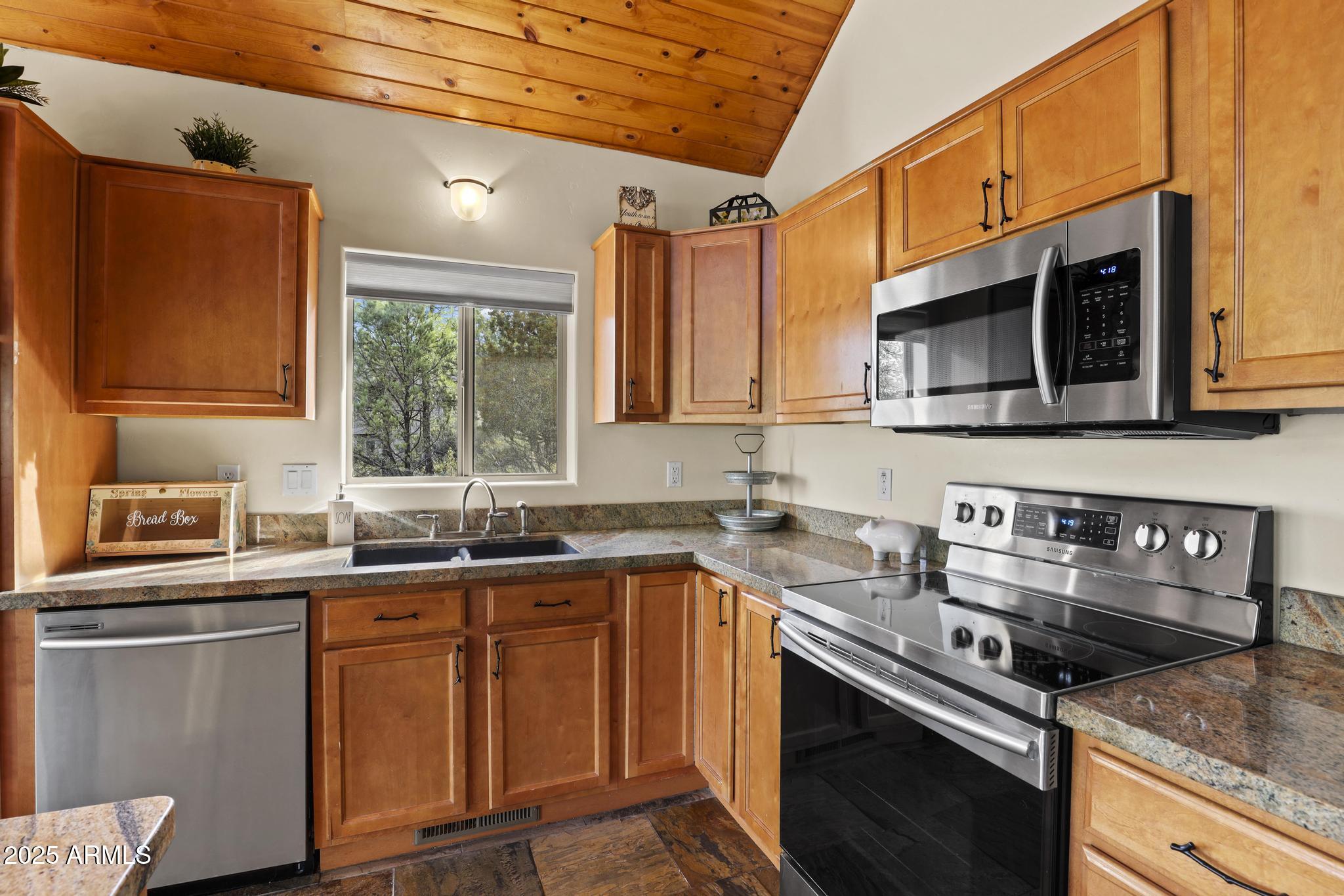 4977 North N Trails Pine, AZ 85544 - Photo 16 of 28 a kitchen with stainless steel appliances a sink stove and microwave