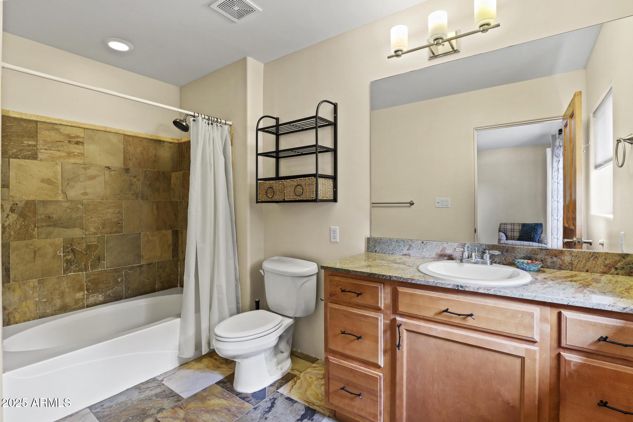 4977 North N Trails Pine, AZ 85544 - Photo 25 of 28 a bathroom with a granite countertop sink toilet a mirror and shower