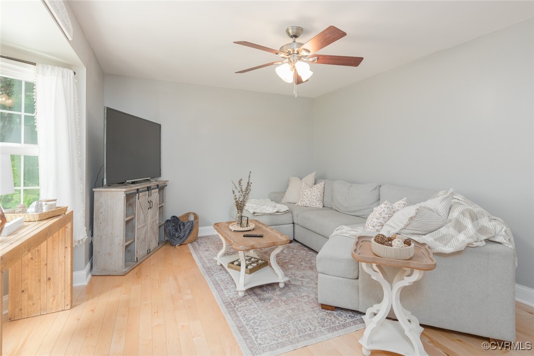 7313 Key Deer Circle Midlothian, VA 23112 - Photo 4 of 45 a living room with furniture a flat screen tv and a window