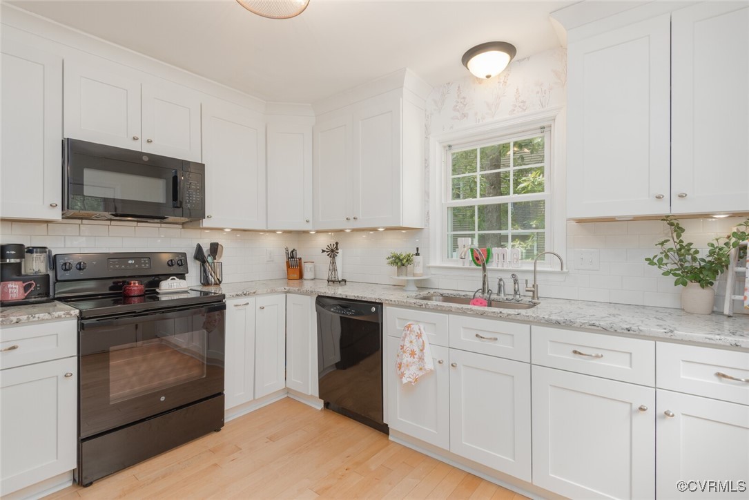 7313 Key Deer Circle Midlothian, VA 23112 - Photo 7 of 45 a kitchen with granite countertop white cabinets sink and stainless steel appliances