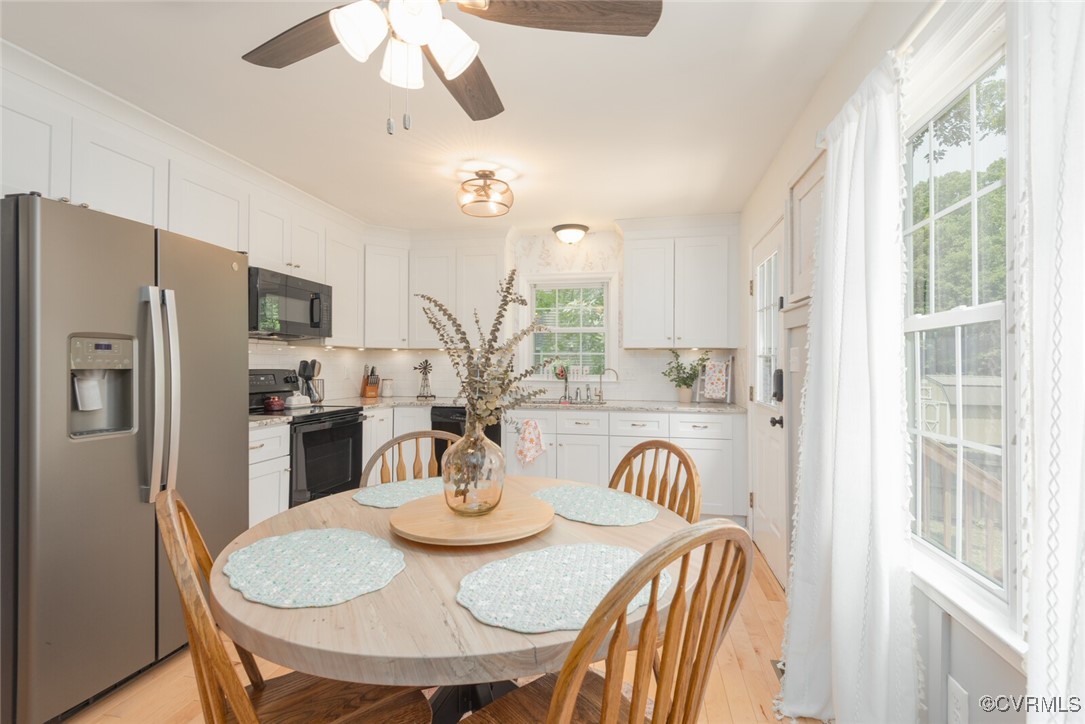 7313 Key Deer Circle Midlothian, VA 23112 - Photo 10 of 45 a view of a dining room with furniture a kitchen and chandelier