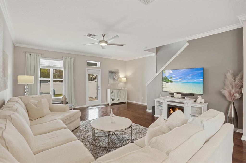 13013 Overstreet Road Windermere, FL 34786 - Photo 11 of 47 a living room with furniture and a flat screen tv