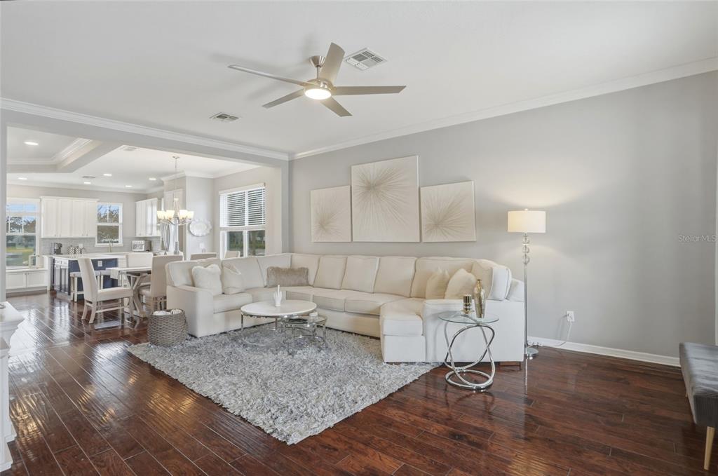 13013 Overstreet Road Windermere, FL 34786 - Photo 12 of 47 a living room with furniture and wooden floor