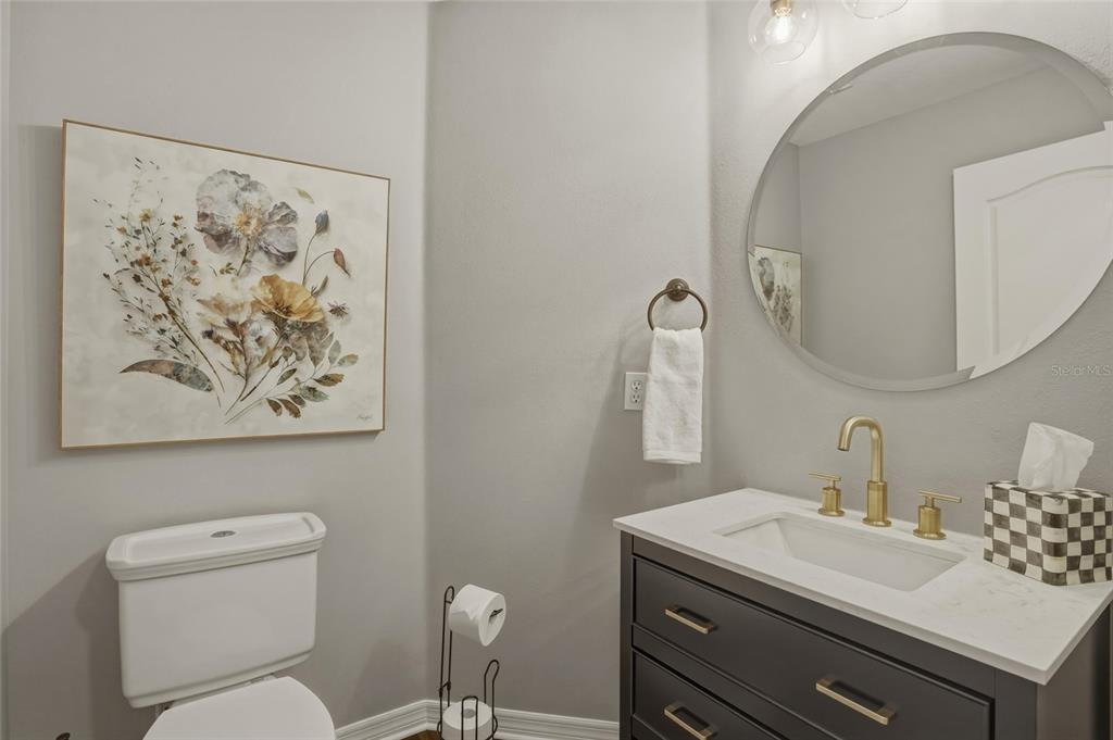 13013 Overstreet Road Windermere, FL 34786 - Photo 14 of 47 a bathroom with a toilet sink and mirror