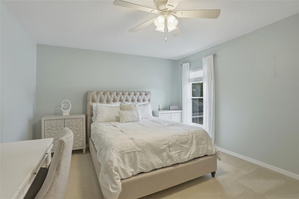 13013 Overstreet Road Windermere, FL 34786 - Photo 15 of 47 a bedroom with a bed and a chandelier