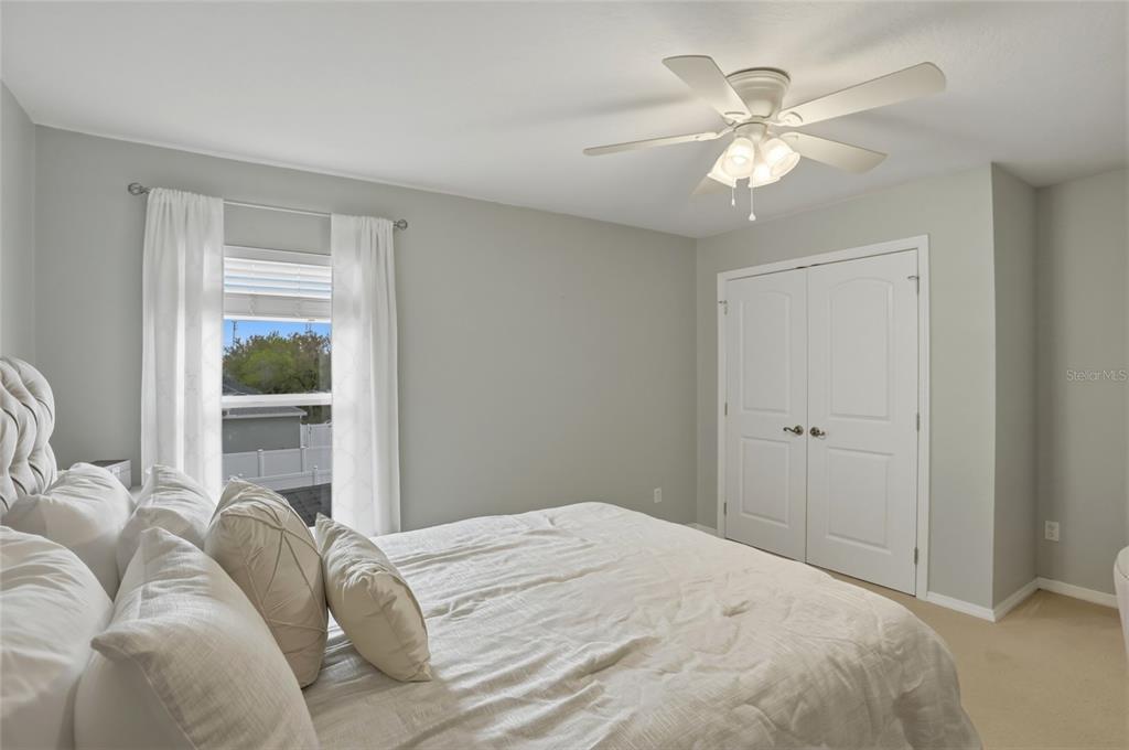 13013 Overstreet Road Windermere, FL 34786 - Photo 16 of 47 a bedroom with a large bed and a window