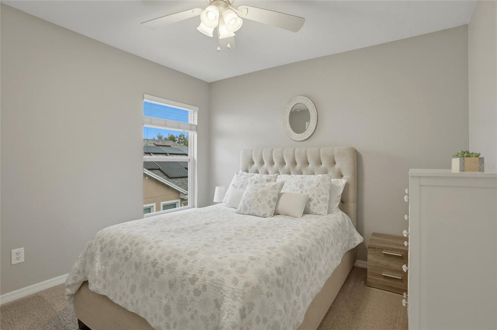 13013 Overstreet Road Windermere, FL 34786 - Photo 19 of 47 a bedroom with a bed and a chandelier