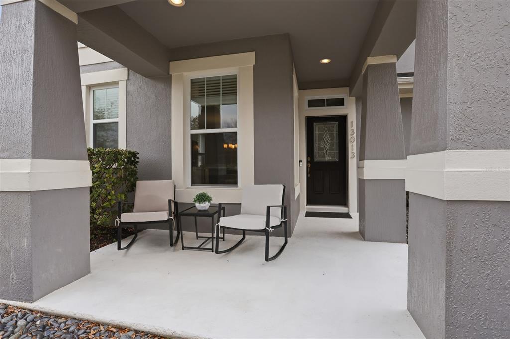 13013 Overstreet Road Windermere, FL 34786 - Photo 2 of 47 a living room with furniture and a potted plant