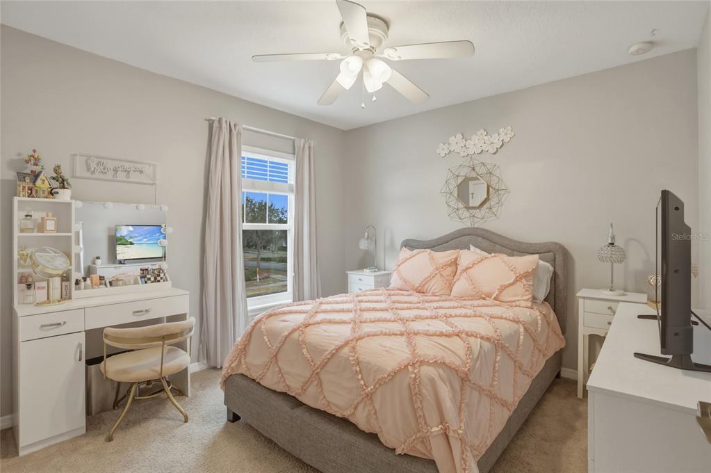 13013 Overstreet Road Windermere, FL 34786 - Photo 21 of 47 a bedroom with a bed and a flat screen tv