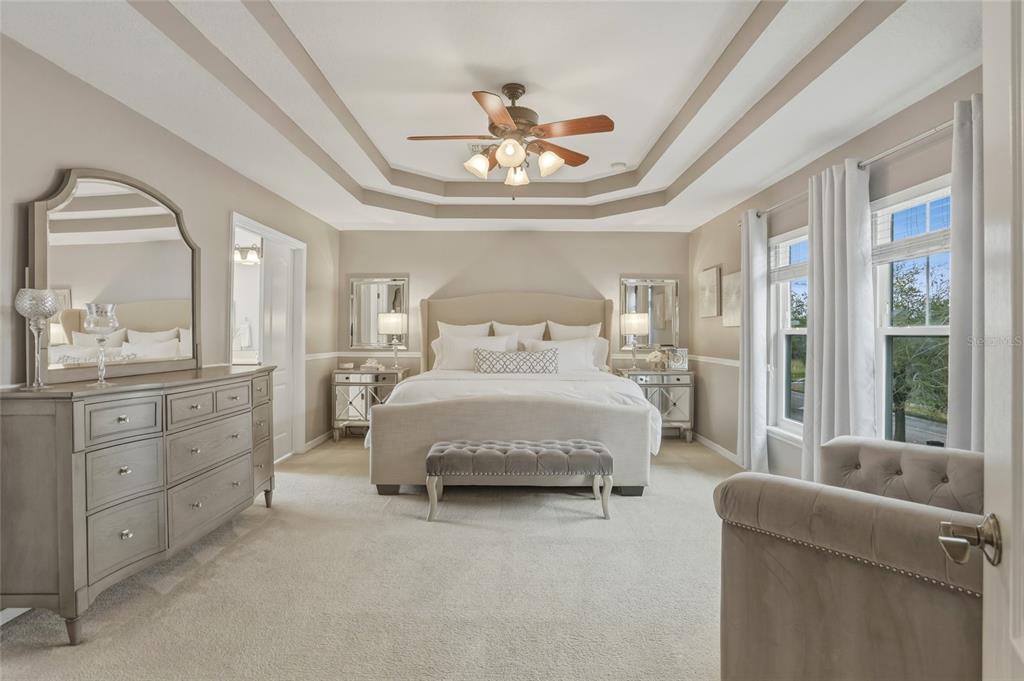 13013 Overstreet Road Windermere, FL 34786 - Photo 22 of 47 a spacious bedroom with a bed and a large mirror