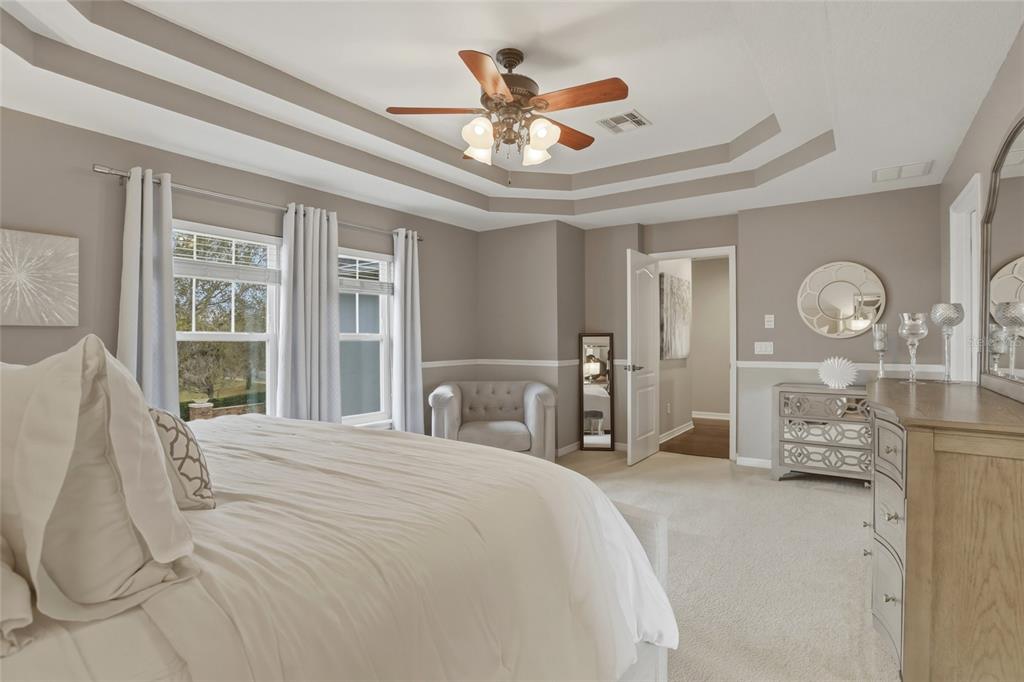 13013 Overstreet Road Windermere, FL 34786 - Photo 24 of 47 a bedroom with a large bed and a chandelier