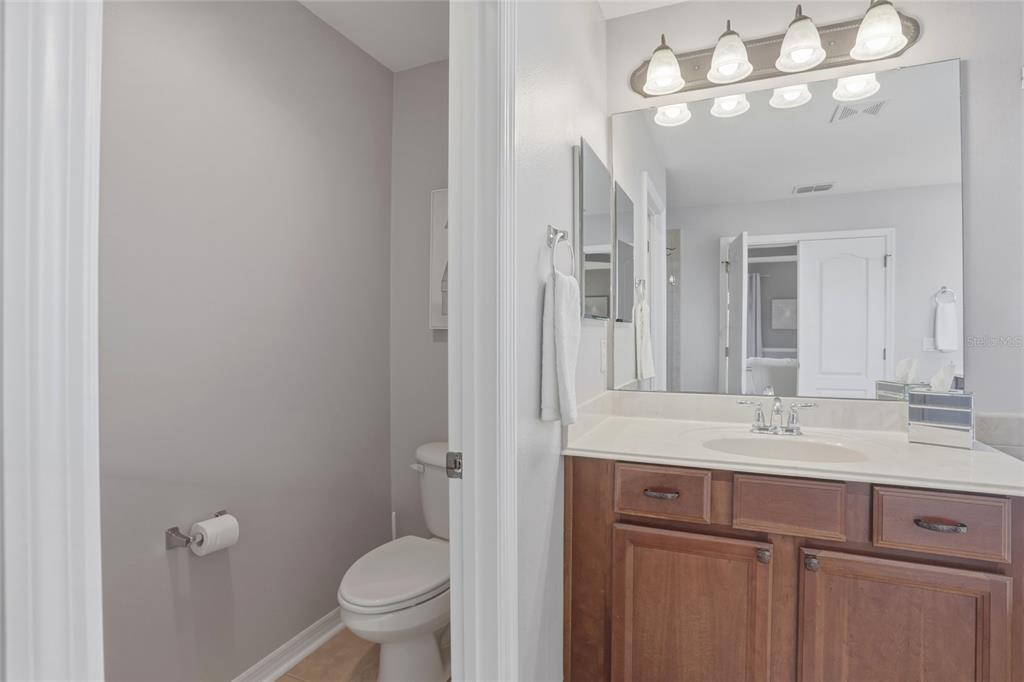13013 Overstreet Road Windermere, FL 34786 - Photo 27 of 47 a bathroom with a sink a toilet and a mirror