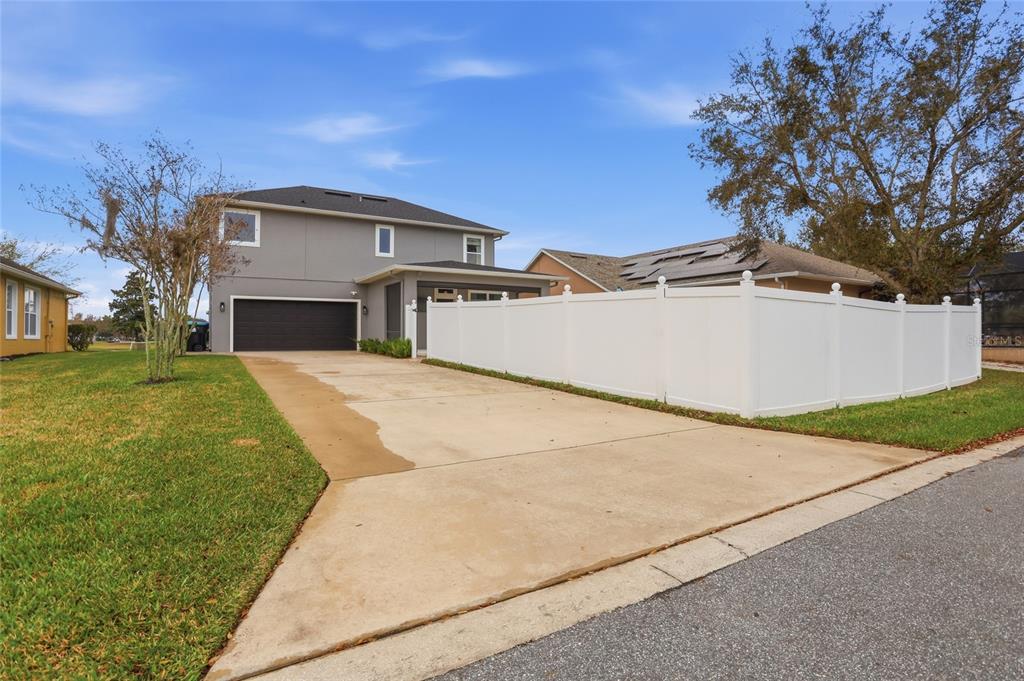 13013 Overstreet Road Windermere, FL 34786 - Photo 41 of 47 a view of a white house with a yard