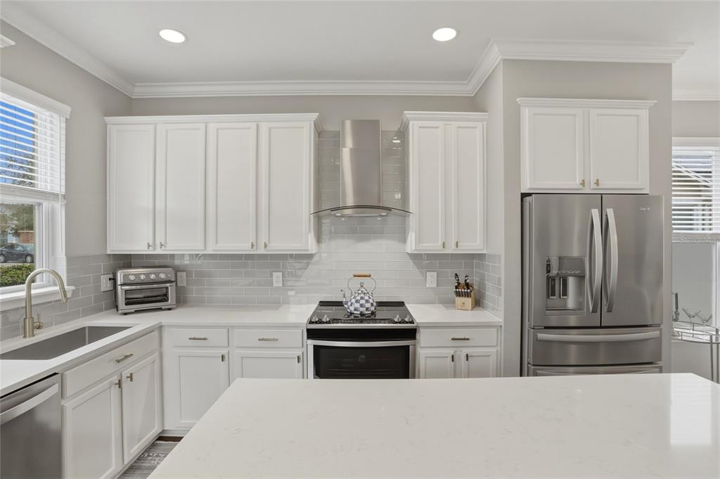13013 Overstreet Road Windermere, FL 34786 - Photo 5 of 47 a kitchen with stainless steel appliances granite countertop a refrigerator sink and cabinets