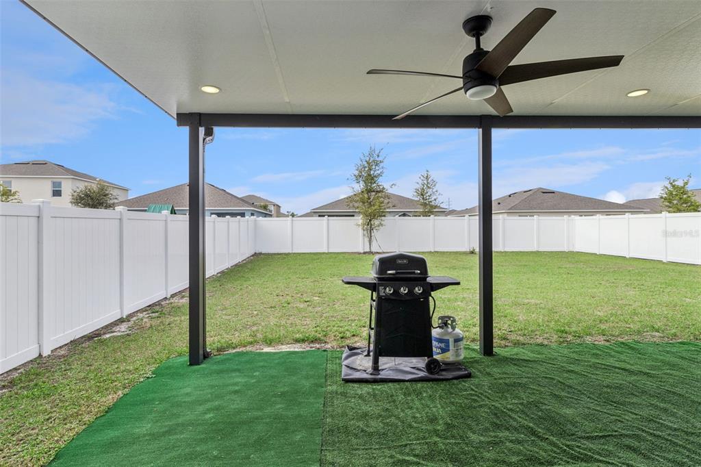 3914 Resting Robin Avenue Bartow, FL 33830 - Photo 35 of 45 a view of a porch with a table chairs and a yard