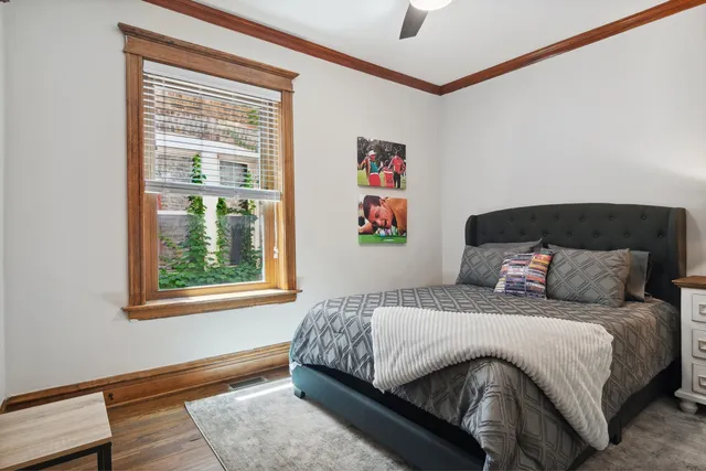 a bedroom with a bed and a window with the outer view