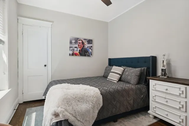 a bedroom with a bed and a window