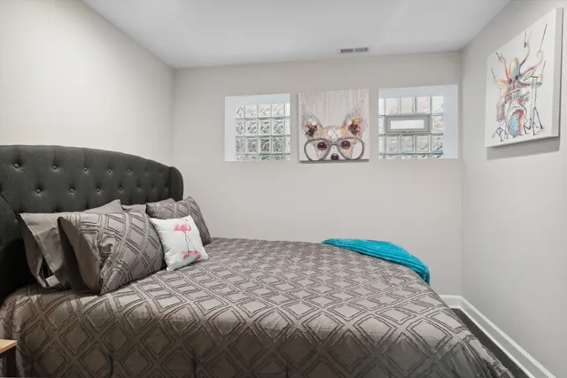 a bedroom with a bed and wall painting