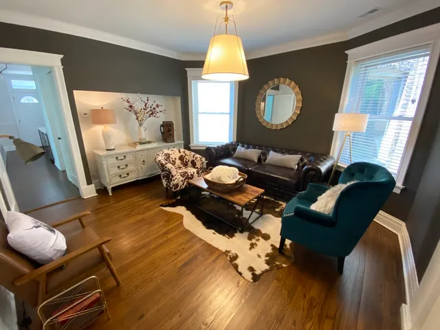 a living room with furniture fireplace and a window