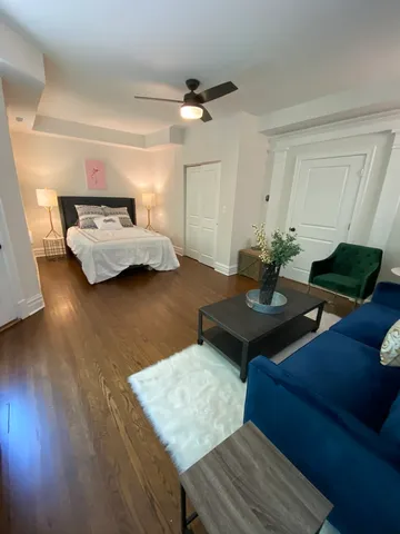 a living room with furniture and a wooden floor