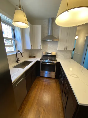 a kitchen with a sink stove and cabinets
