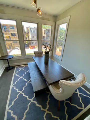 a view of a dining room with furniture wooden floor and a chandelier