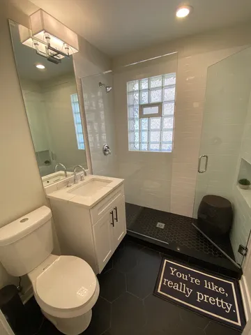 a bathroom with a sink toilet and a mirror